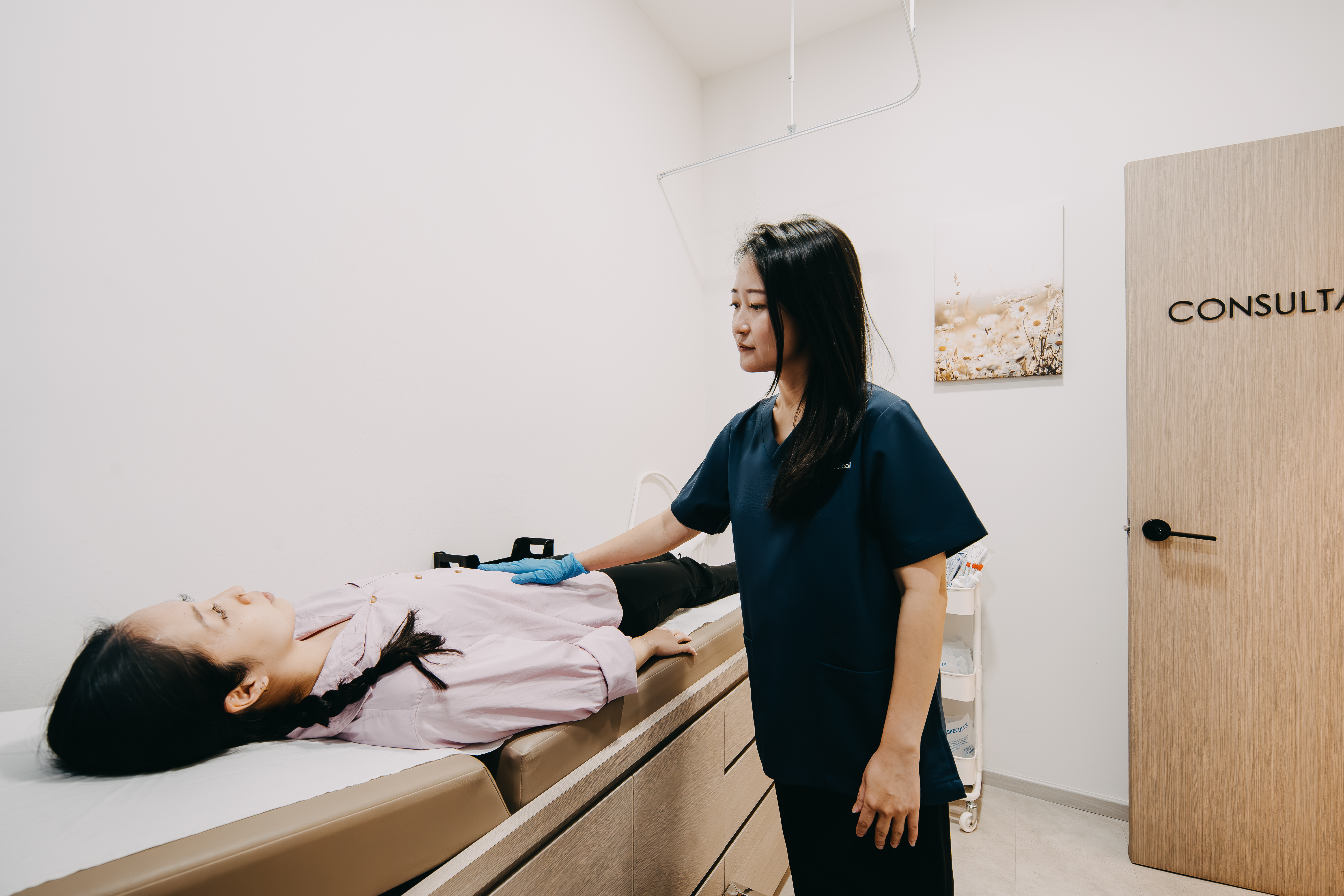 Female doctor performs initial health assessment on woman for personalised weight loss programme