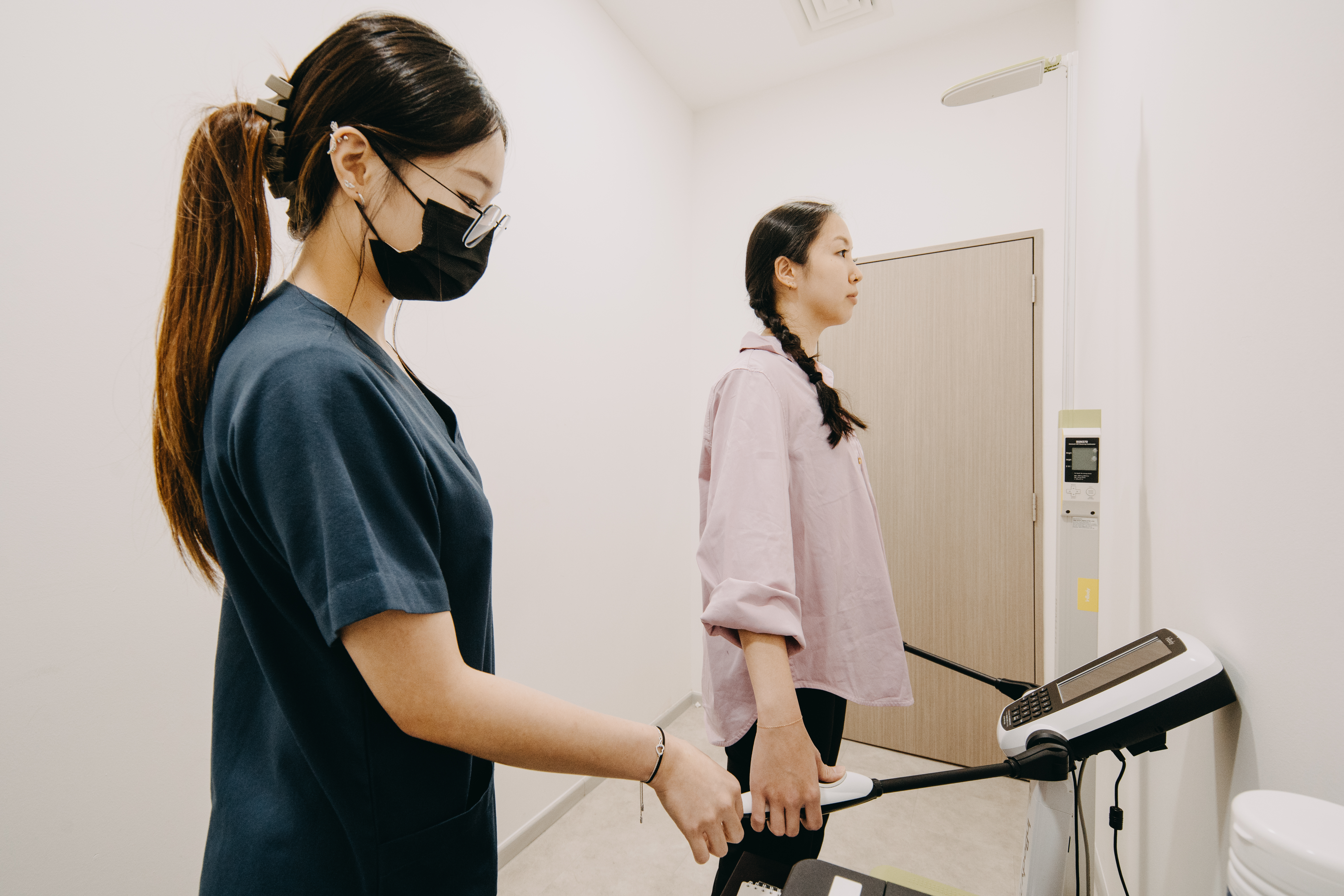 Woman’s body composition and BMI being measured by an InBody scan by nurse for weight loss plan