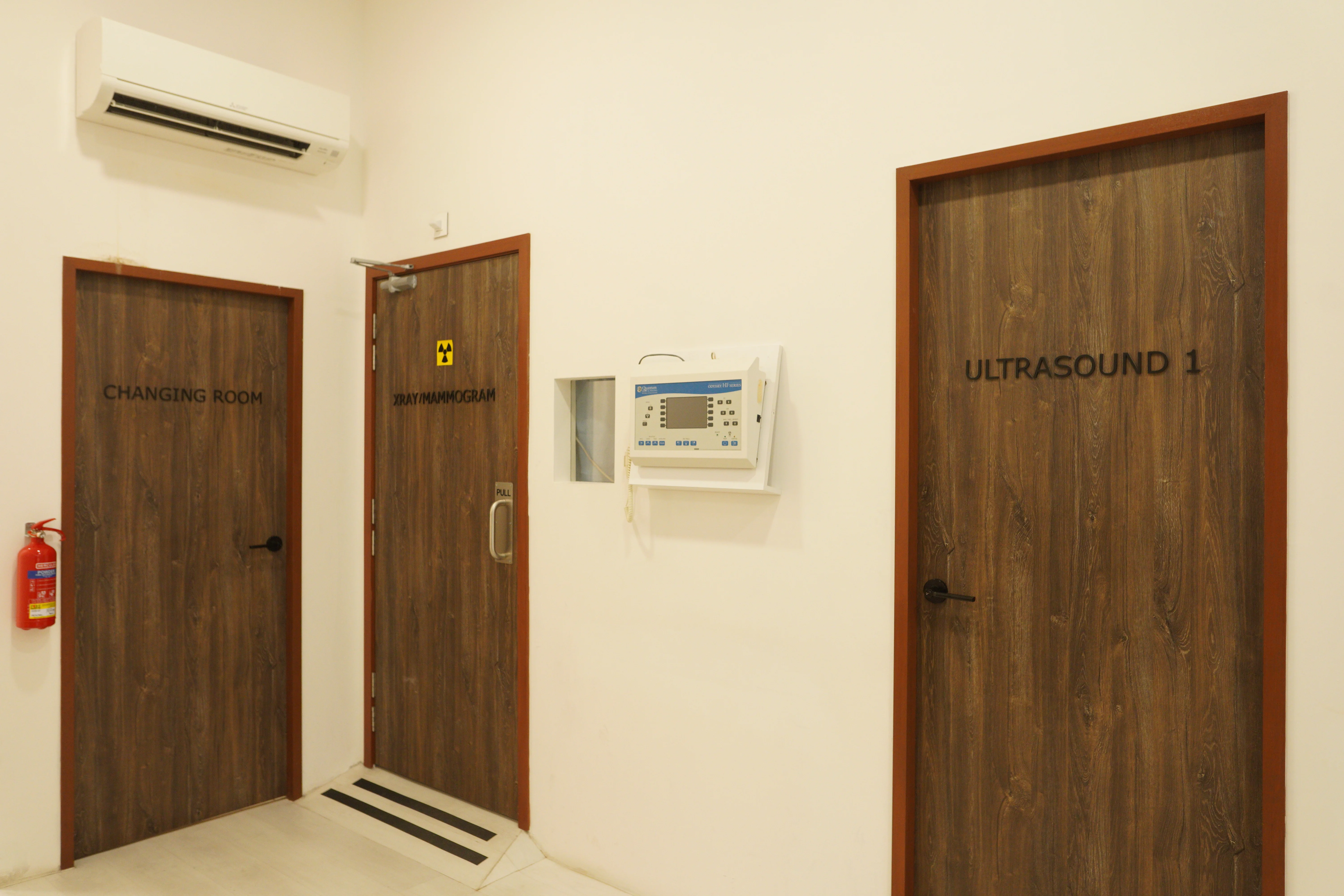 Changing room, X-ray/mammogram room, and ultrasound room at Singapore Women's Clinic.