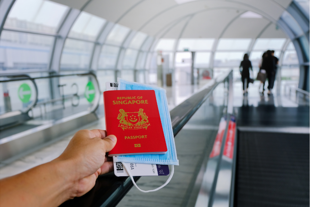 Traveller at Singapore airport preparing for overseas trip while continuing malaria prophylaxis.
