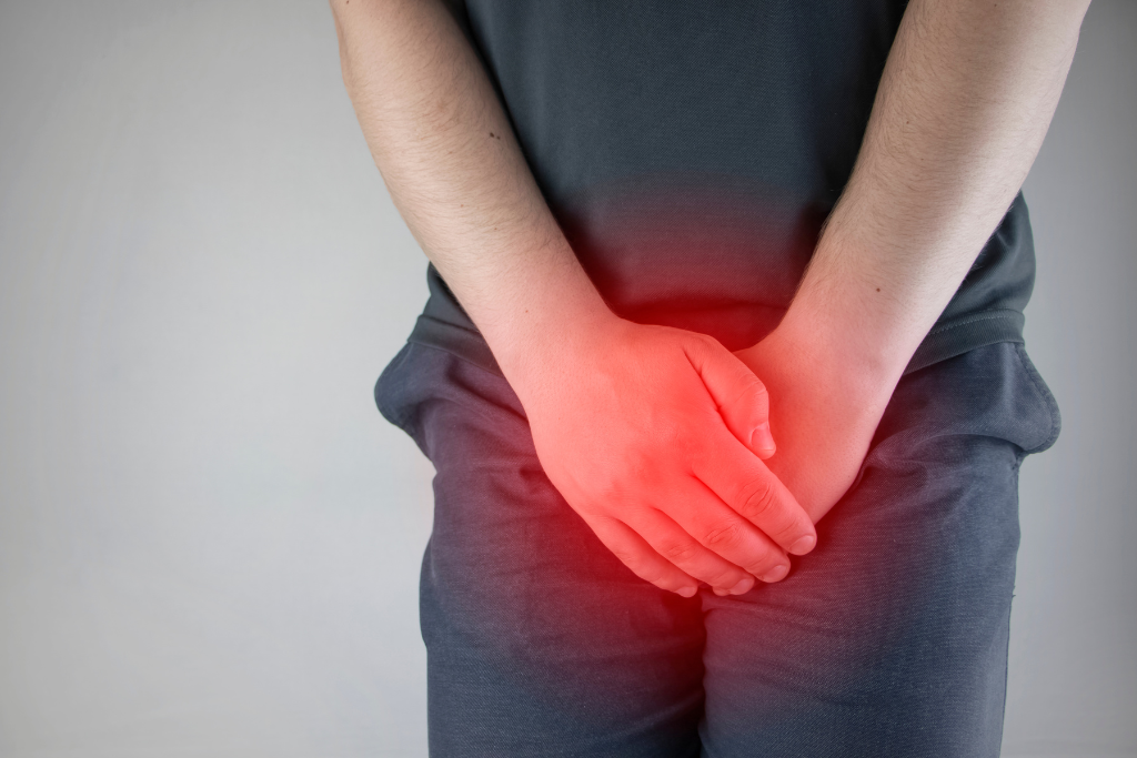 Man holding groin with pain showing symptoms of ureaplasma infection such as burning urination.