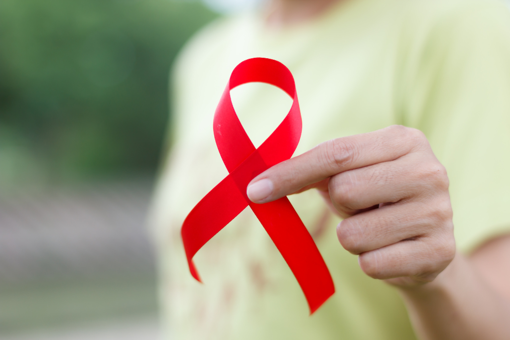Woman holding red hiv awareness ribbon representing hiv testing diagnosis prevention and support.