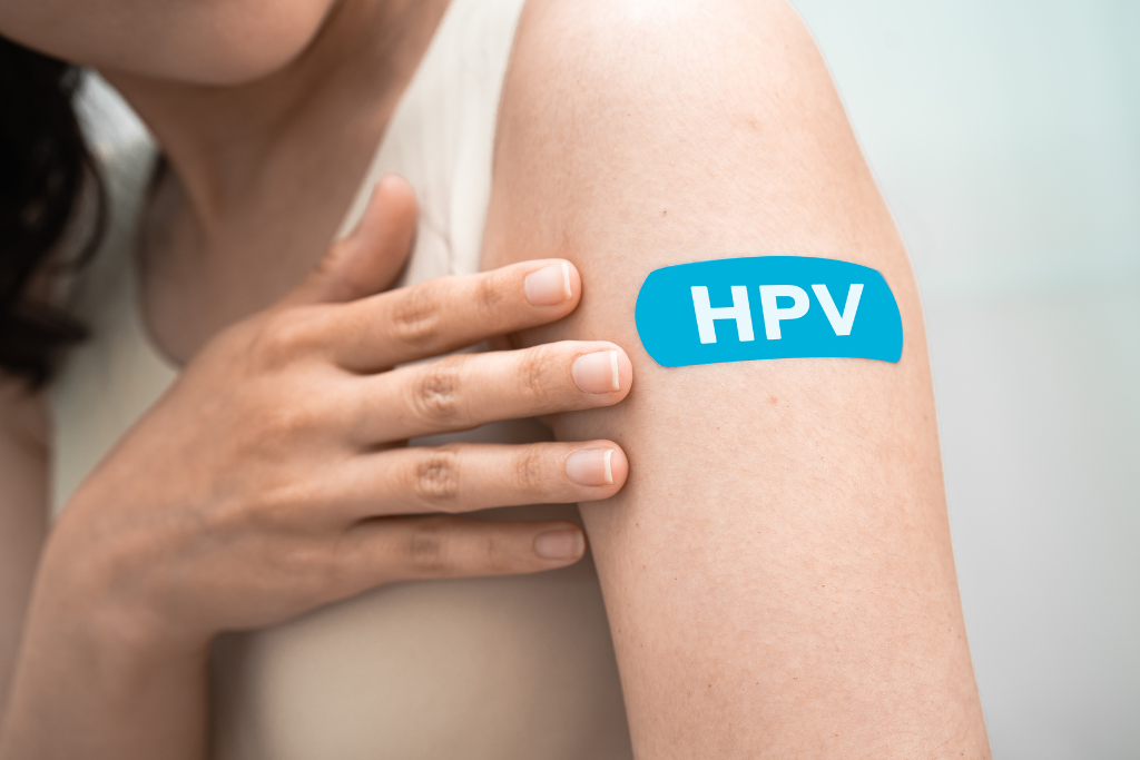 Woman receiving hpv vaccine on upper arm to reduce risk of infection and prevent complications.