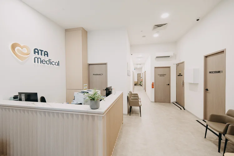 Clinic reception desk with a corridor of treatment rooms behind it