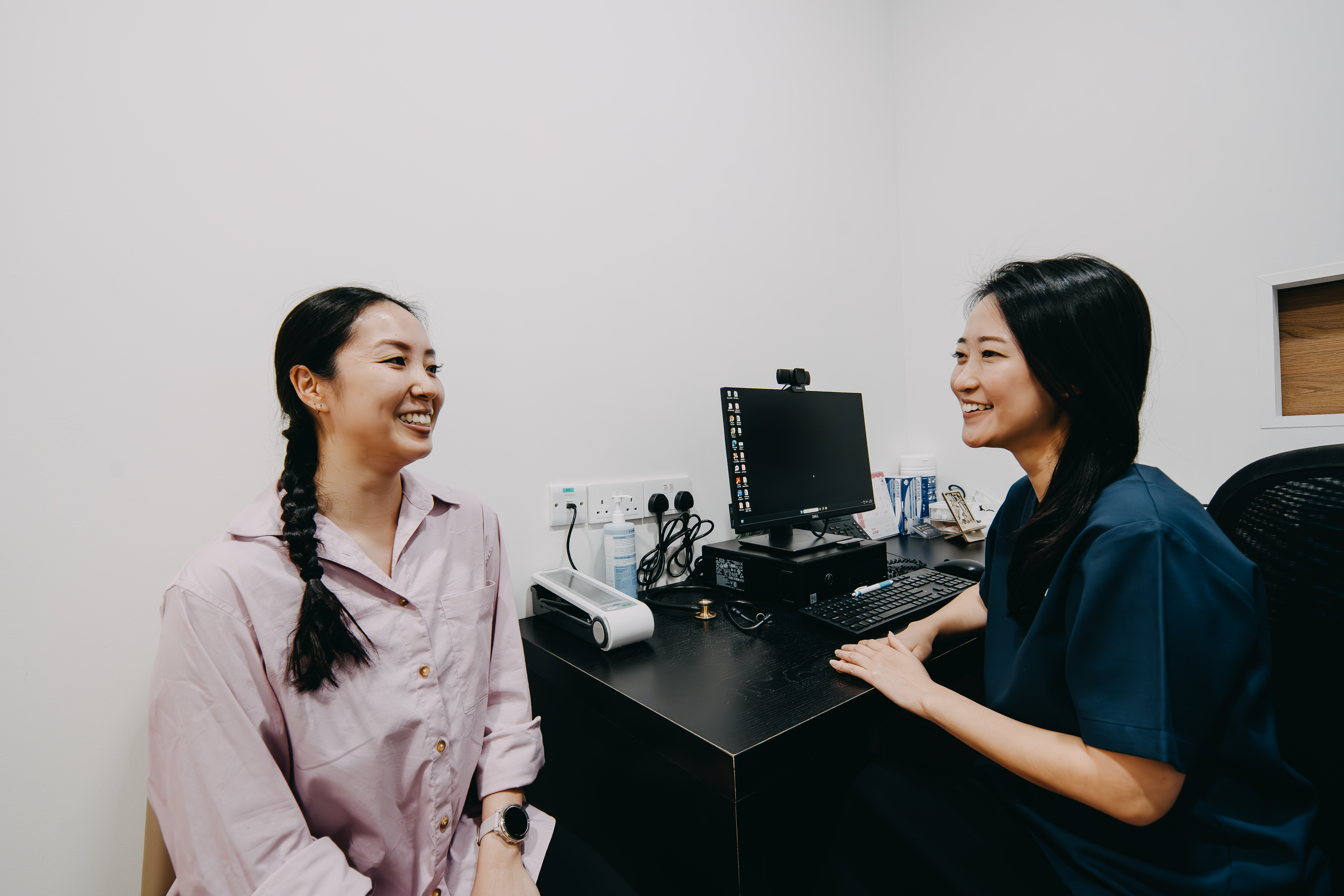 Woman consulting female doctor for medically supervised weight loss programme in Singapore.