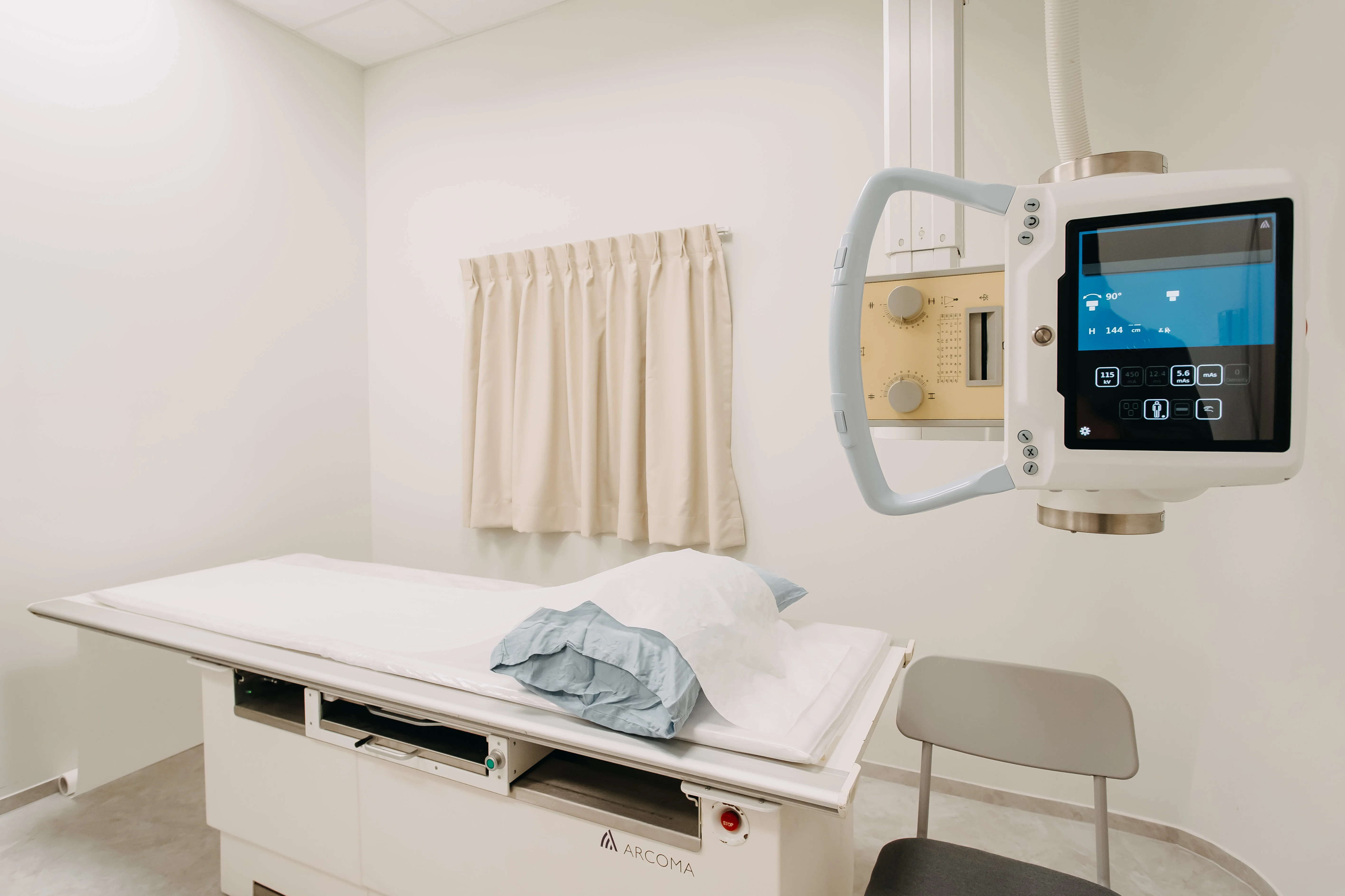 X-ray imaging machine with examination table at Singapore Women's Clinic for medical check-ups.